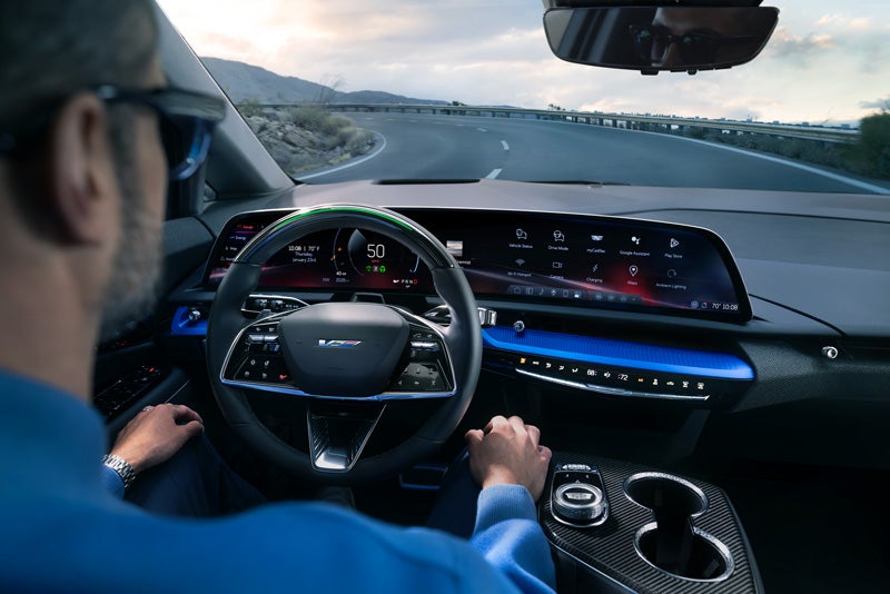 Front View of the 2026 OPTIQ-V Driving Through the Dusk Utilizing its Headlights | Rick Bokman Cadillac in OLEAN NY